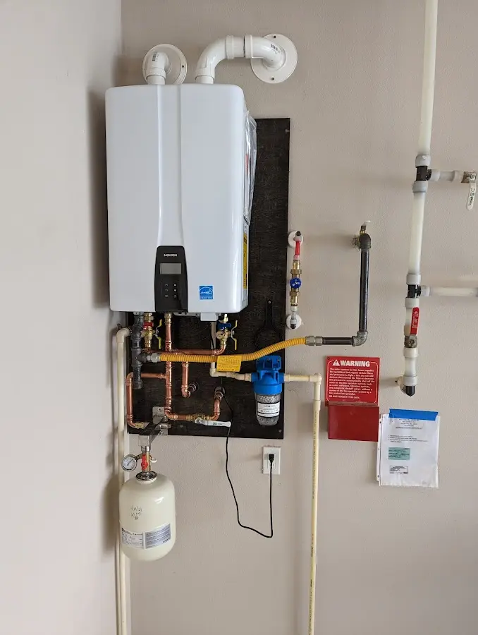 Professional plumber installing copper piping in a Florissant home